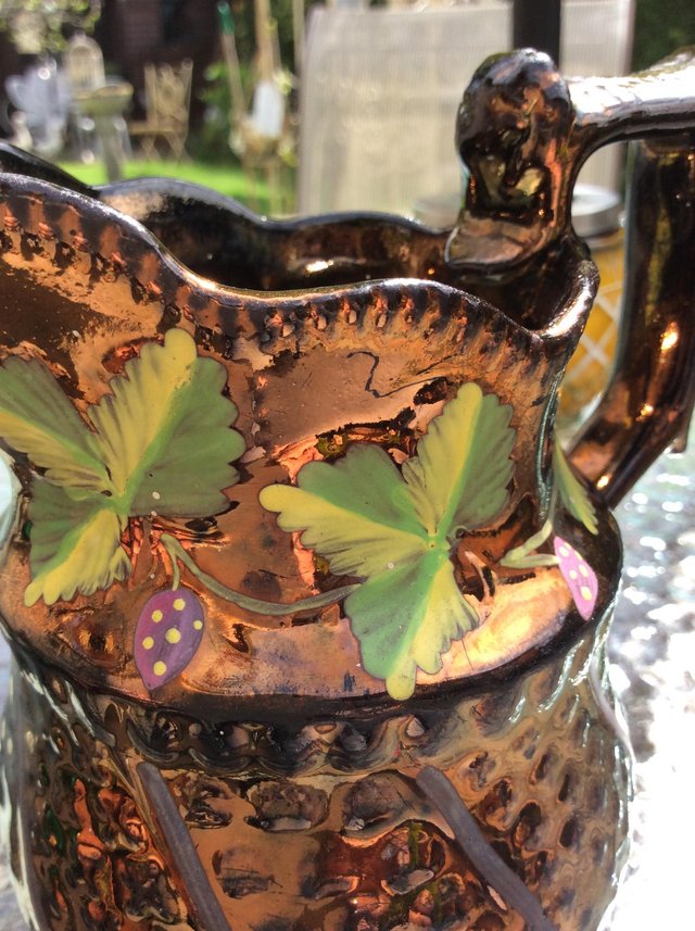 Preview of the first image of Antique copper luster jug with painted ivy leaves..