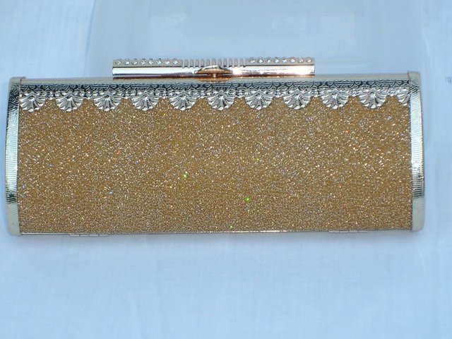 Preview of the first image of Gold Lamé Hard Shell Handbag/Clutch NEW.