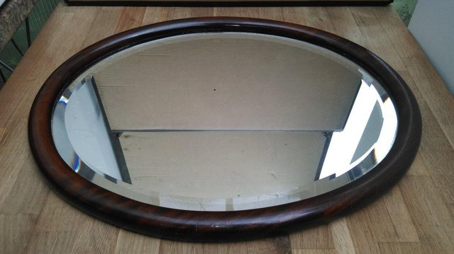 Preview of the first image of Antique Rich Rosewood oval framed bevel mirror.