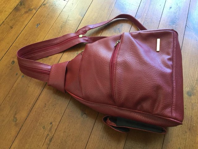 Preview of the first image of Red handbag worn rucksack style.