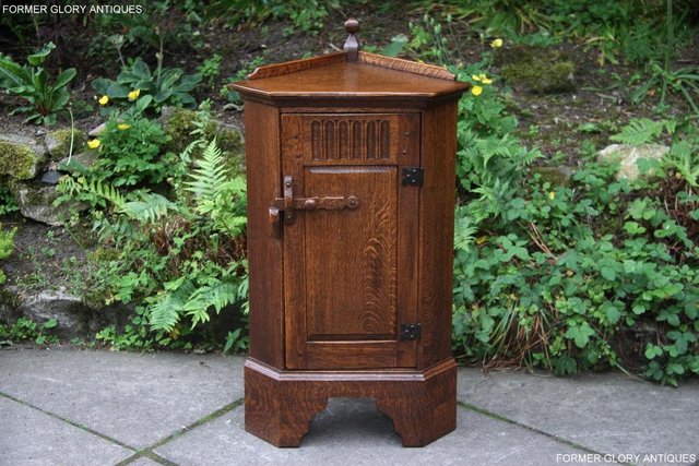 Preview of the first image of A NIGEL RUPERT GRIFFITHS CARVED OAK CORNER CABINET CUPBOARD.