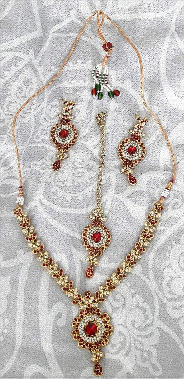 Preview of the first image of Indian wedding gold and red jewellery set.