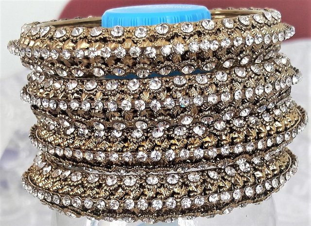 Preview of the first image of 4 Indian gold and diamante wedding bangles.