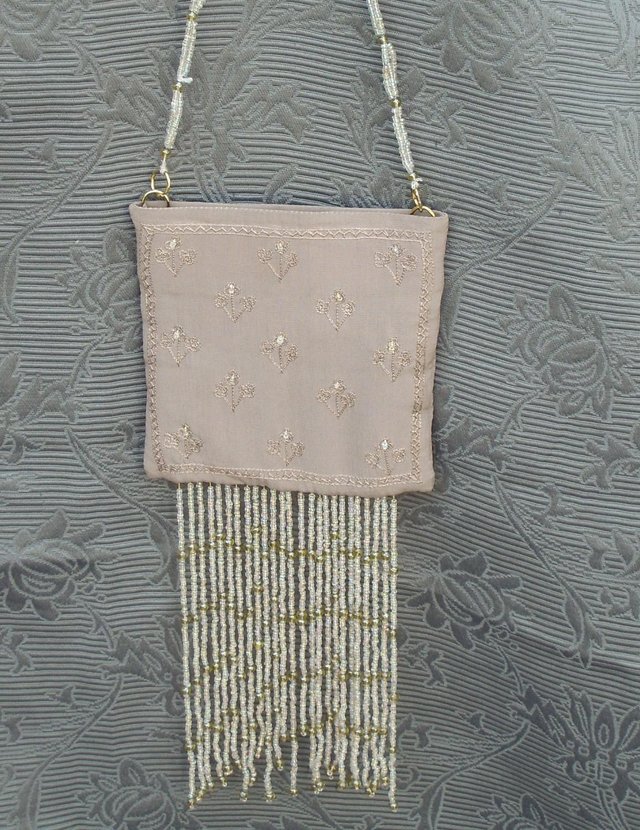 Preview of the first image of Nude/Pink Fringed Evening Shoulder Bag.