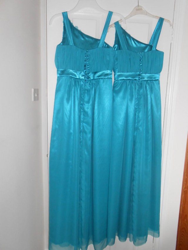 Preview of the first image of 2 stunning Turquoise (unworn) early-teen Bridesmaid dresses.