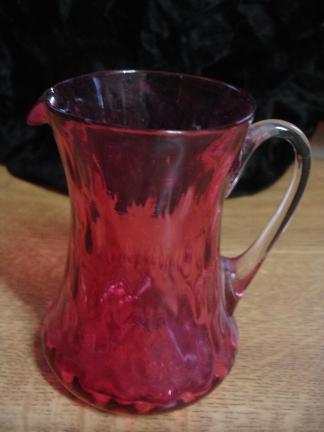 Preview of the first image of SMALL ANTIQUE CRANBERRY GLASS JUG.