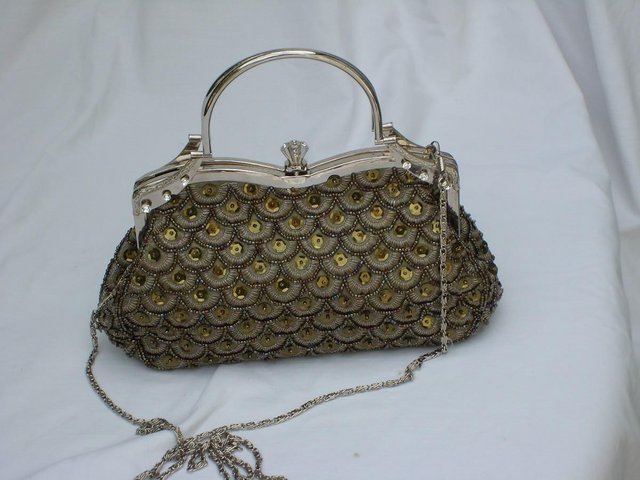 Preview of the first image of Gold Snap Top Sequin Handbag.