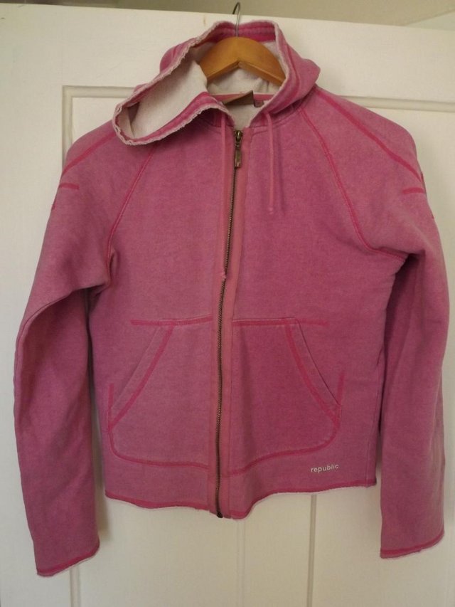 Preview of the first image of Republic long sleeved pink hooded zip top.