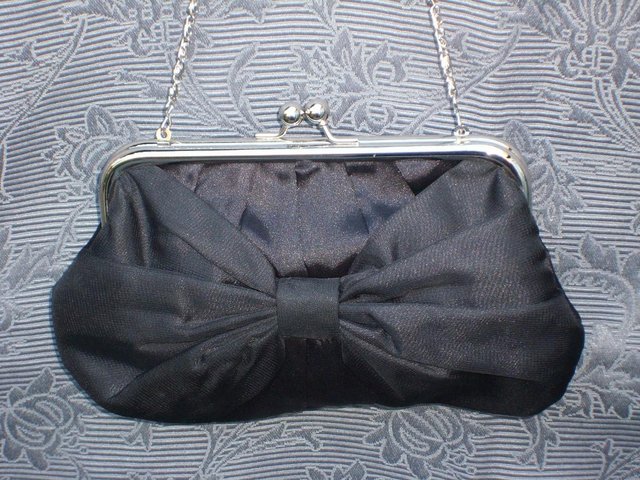 Preview of the first image of ACCESSORIZE Black Satin Bow Handbag/Clutch.