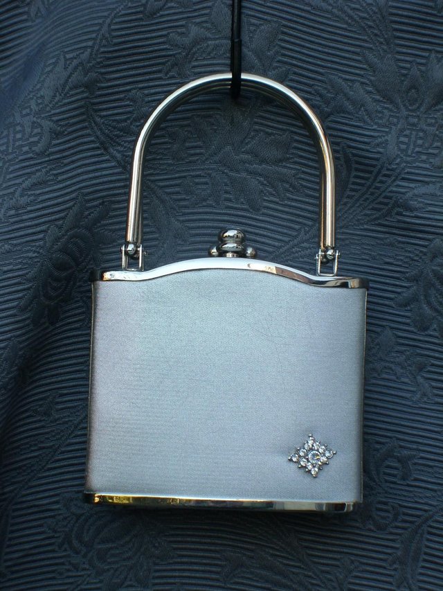 Preview of the first image of Silver Lamé Hard Shell Evening Bag.