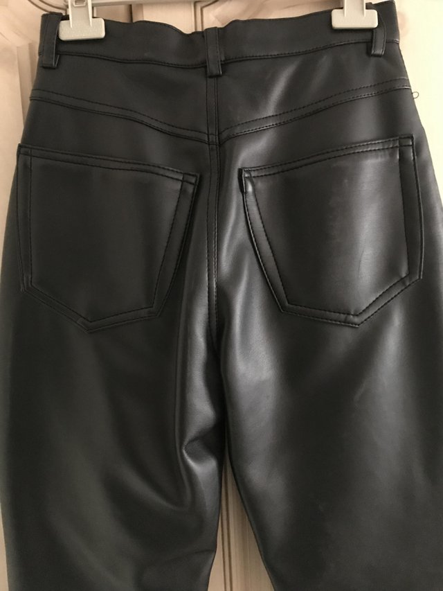Preview of the first image of New PVC Black Leather look trousers.