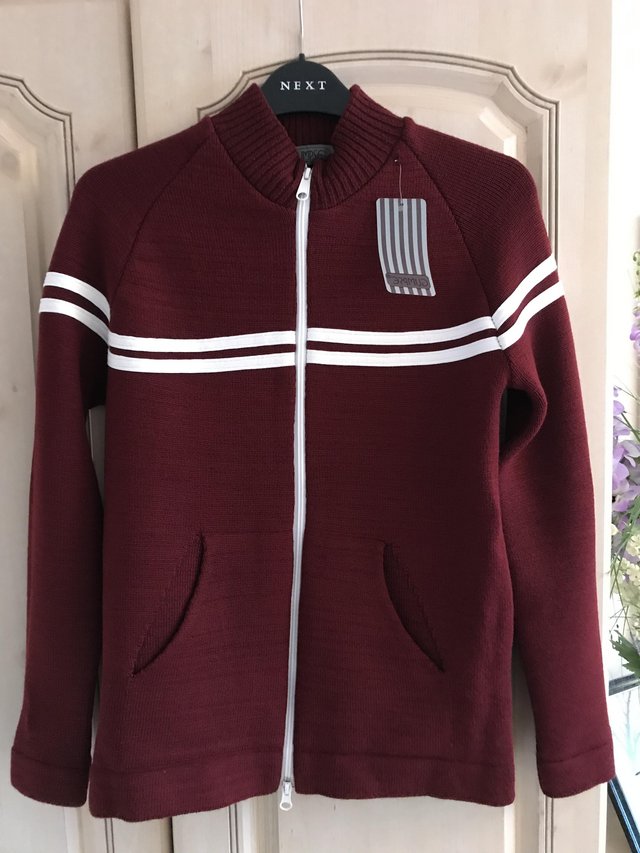 Preview of the first image of Brand New Burgundy zip up cardigan, still with label.