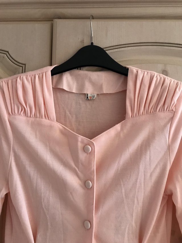 Preview of the first image of Attractive Peach top with ruched shoulders, size 10.