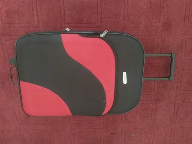 Preview of the first image of Pair of Fiore black and red, trolley cabin bags.