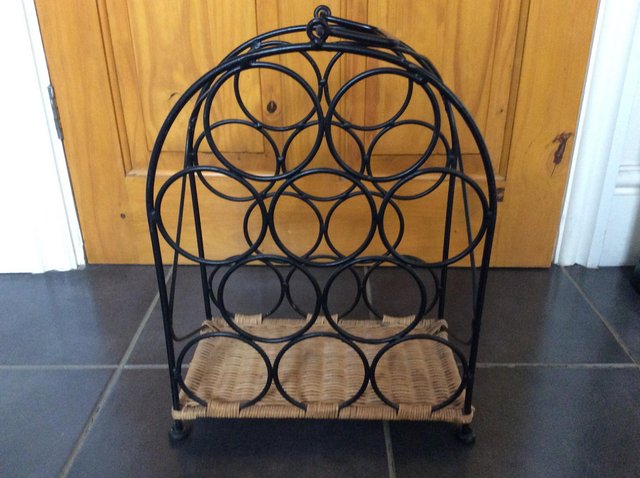 Preview of the first image of Black Metal and Wicker Wine Rack Storage.