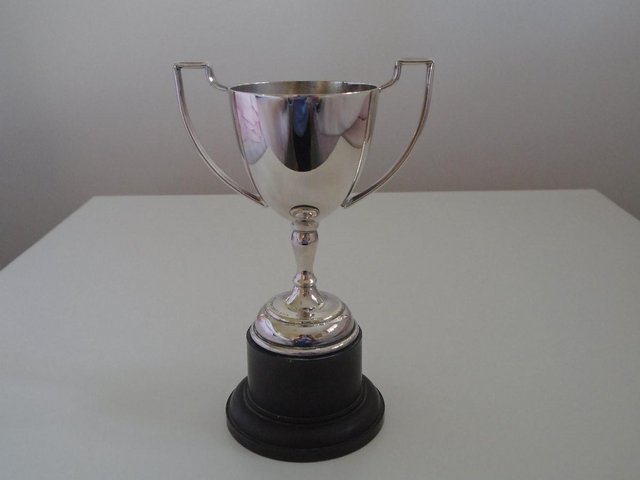 Preview of the first image of Silver-plated 2 and 1/4 inch trophy.