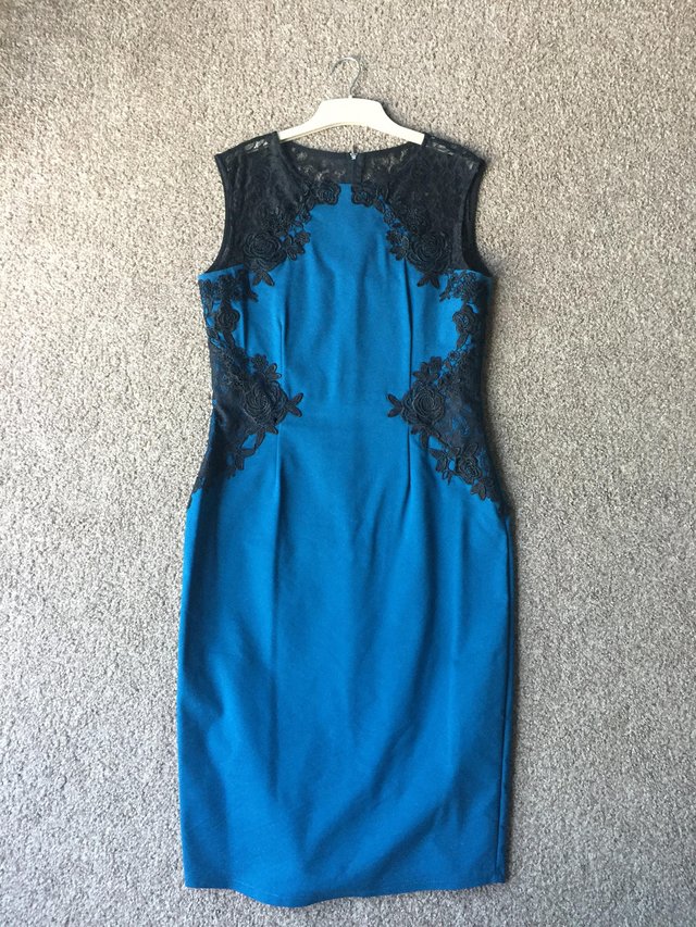 Preview of the first image of Petrol blue bodycon dress with lace.
