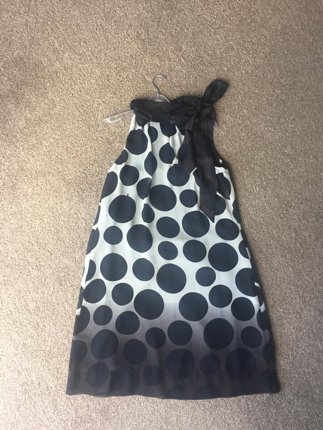 Preview of the first image of Black polka dot trapeze dress.