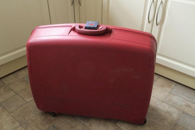 Preview of the first image of Delsey Red Hard Rolling 3-Lock Pullman Suitcase with Extras.