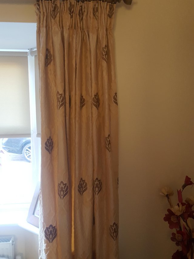 Preview of the first image of Two pairs of Gold coloured lined curtains.