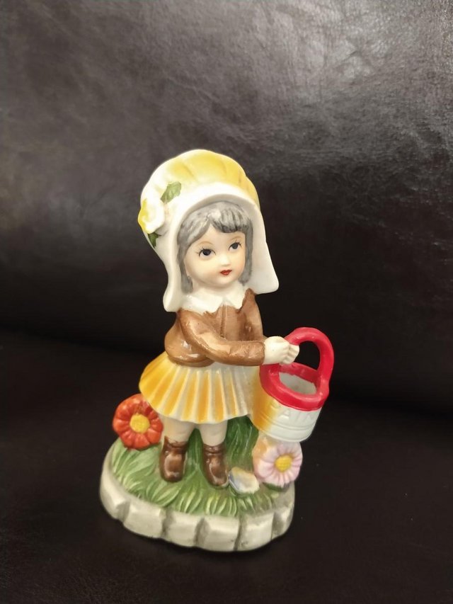 Preview of the first image of Porcelain Figurine Girl with Yellow Bonnet + bucket/pail..