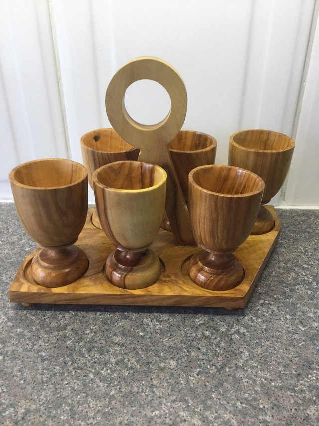 Preview of the first image of Olive wood set of 6 egg cups on carrying stand.