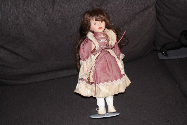 Preview of the first image of Porcelain Doll on stand.