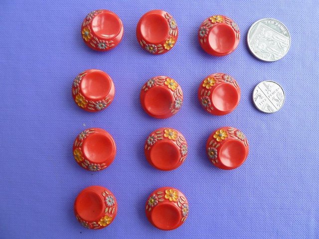 Preview of the first image of 11 Vintage red buttons, flowers around edge.