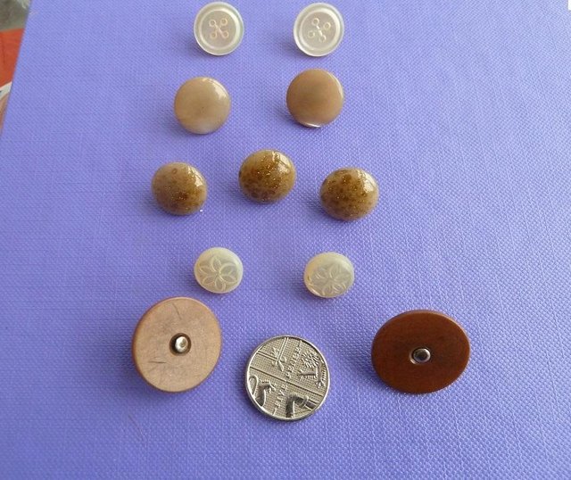Preview of the first image of 11 vintage buttons, Victorian to 1950's.