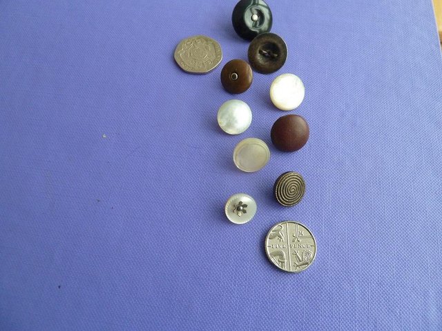 Preview of the first image of 9 vintage buttons from Victorian to 1950's.