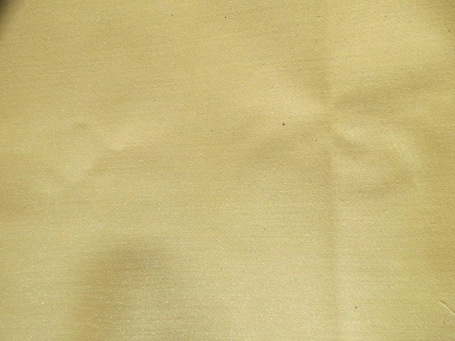 Preview of the first image of Fabric remnant plain soft yellow coloured sateen.