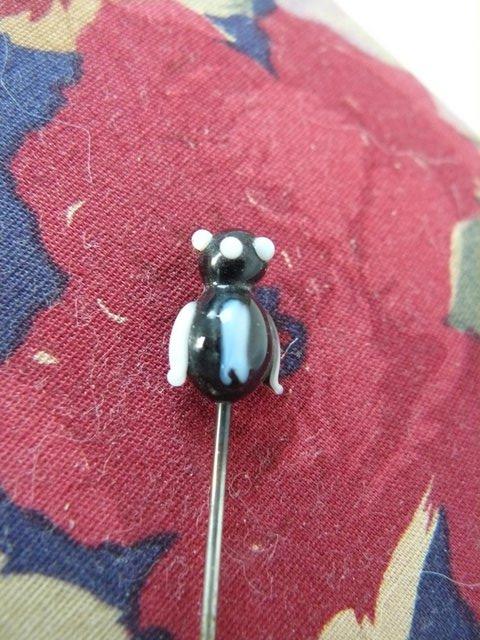 Preview of the first image of Antique metal hatpin with small black & white glass penguin.