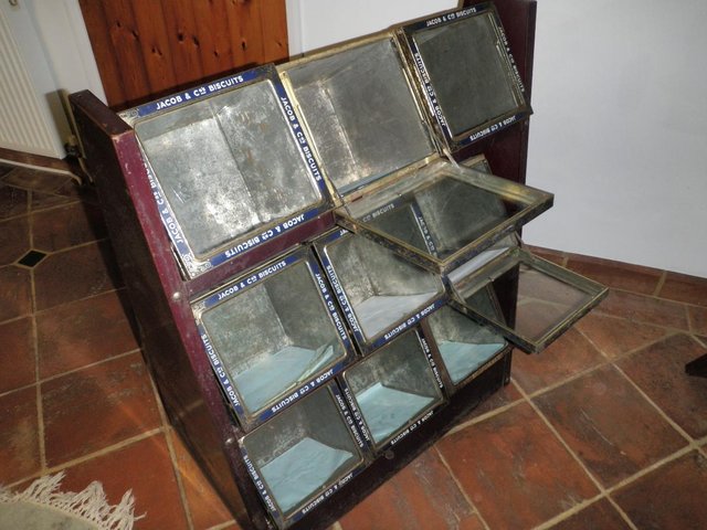 Image 3 of NINE BISCUIT TINS with GLASS LIDS IN A DISPLAY STAND