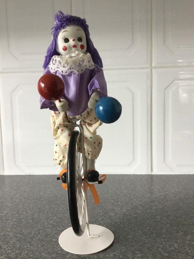 Preview of the first image of Clown on one wheel bike with balloons.