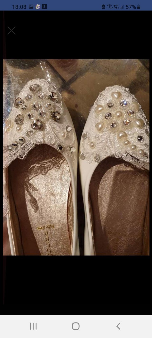 Preview of the first image of For sale brand new white lace and crystal wedding shoes.