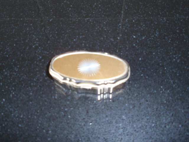 Preview of the first image of Oval Shaped Brass Coloured Metal Pill Box.