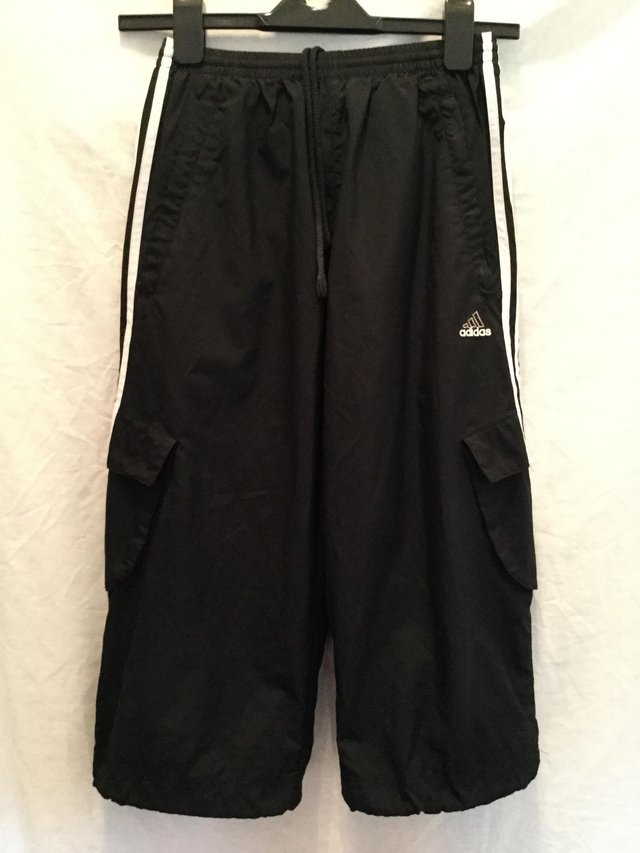 Preview of the first image of Adidas black three quarter shorts.