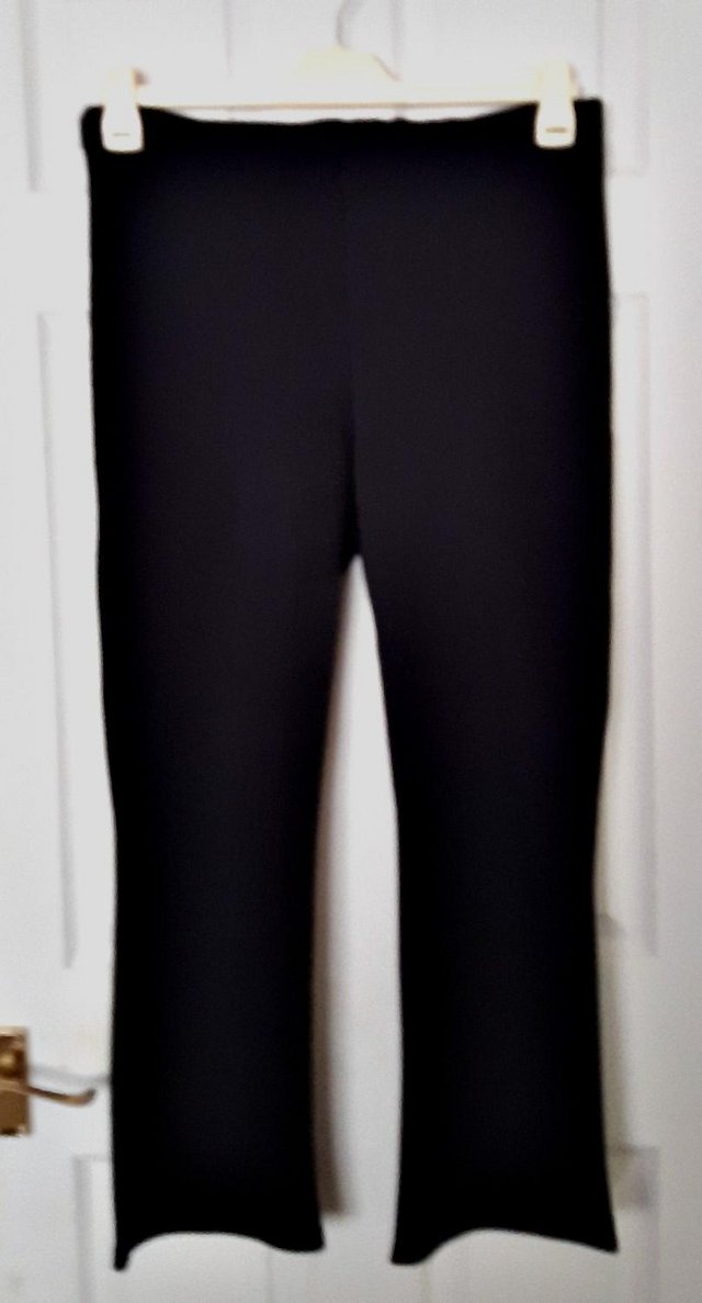 Preview of the first image of Ladies Black Fine Ribbed Pull On Bootcut Trousers - Size 20.