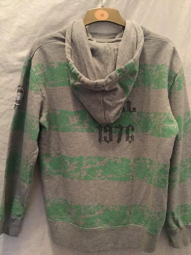 Image 3 of A grey, green casual hoody with motifs