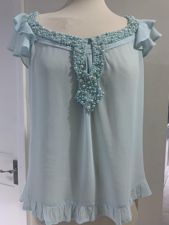 Preview of the first image of Pretty turquoise beaded chiffon size 10 top.