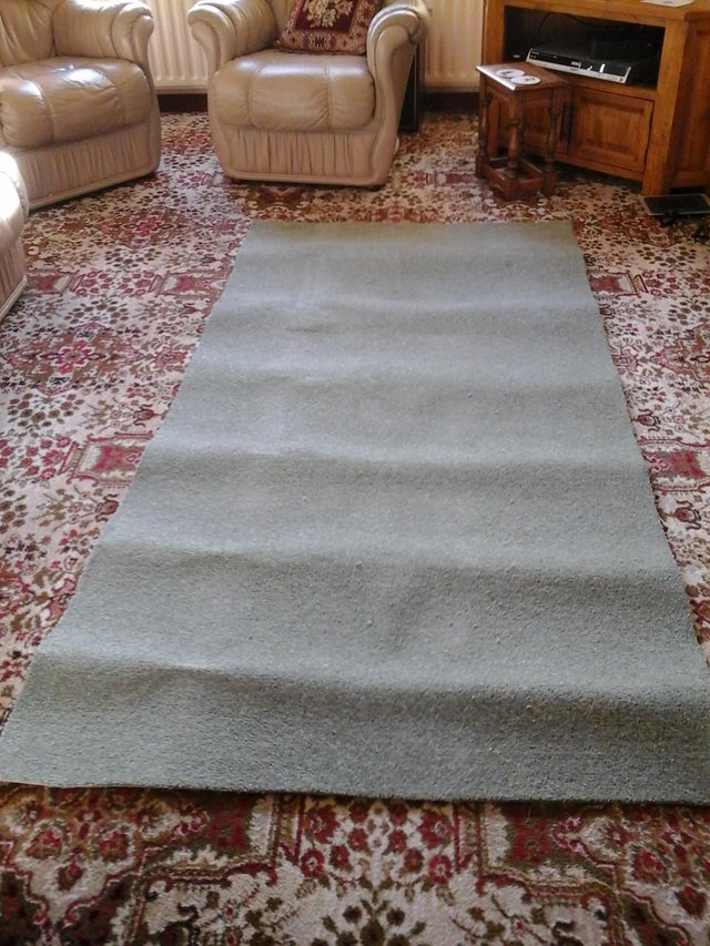 Preview of the first image of Green carpeting, ideal as a rug.