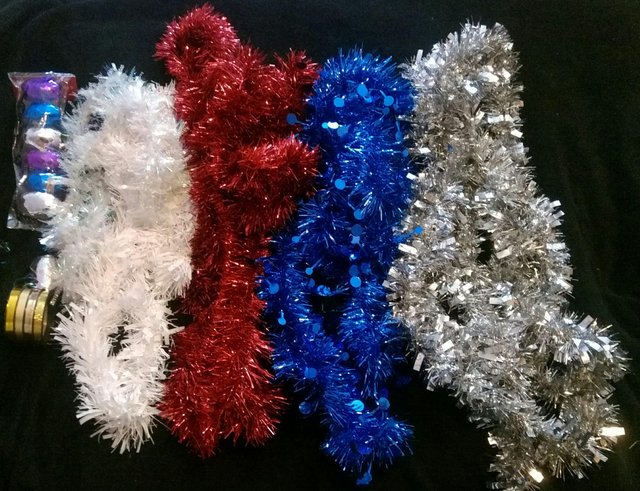 Preview of the first image of Six Tinsel various colours and sizes.