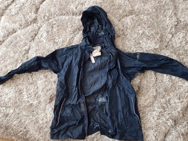 Preview of the first image of Regatta navy pack away waterproof jacket aged 9-10 years.
