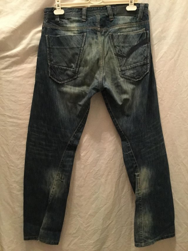 Preview of the first image of Cherokee twisted seam dark and faded jeans.