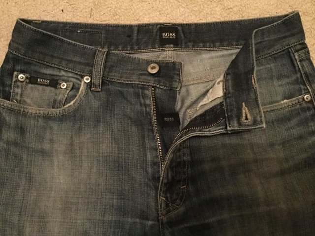 Preview of the first image of Designer distressed blue jeans by Next.