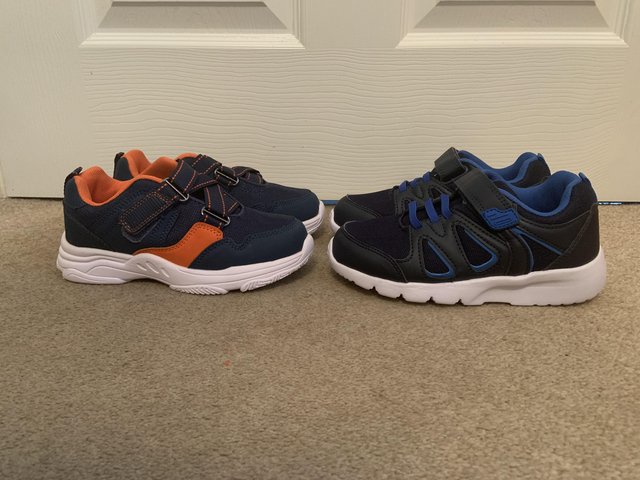 Preview of the first image of 2 pairs of brand new children’s trainers.