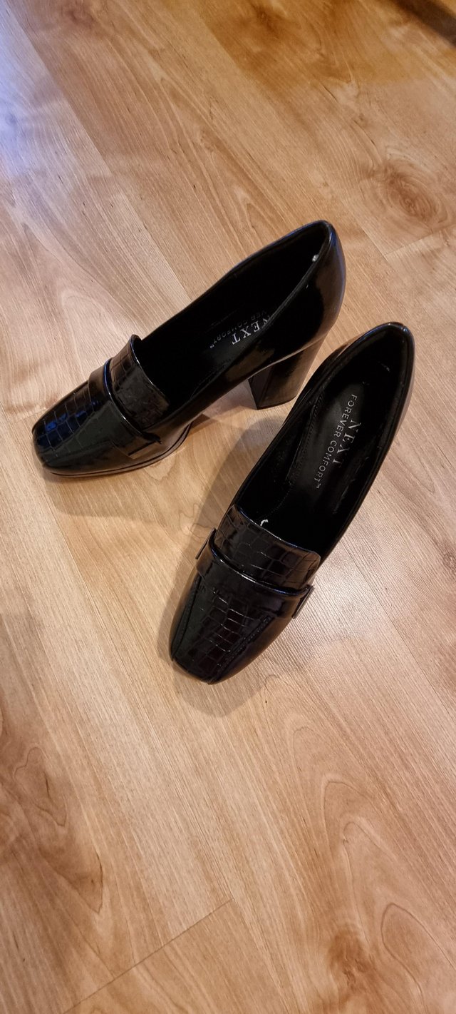 Preview of the first image of Women's black patent loafer shoes.