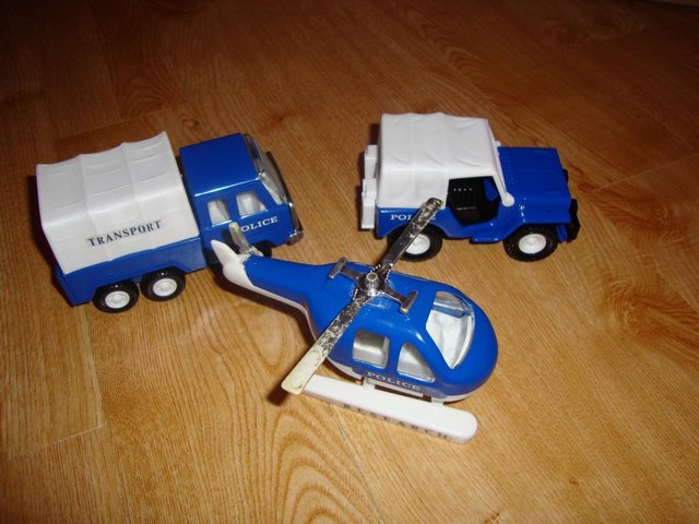 Preview of the first image of Vintage police transport truck, van and helicopter.