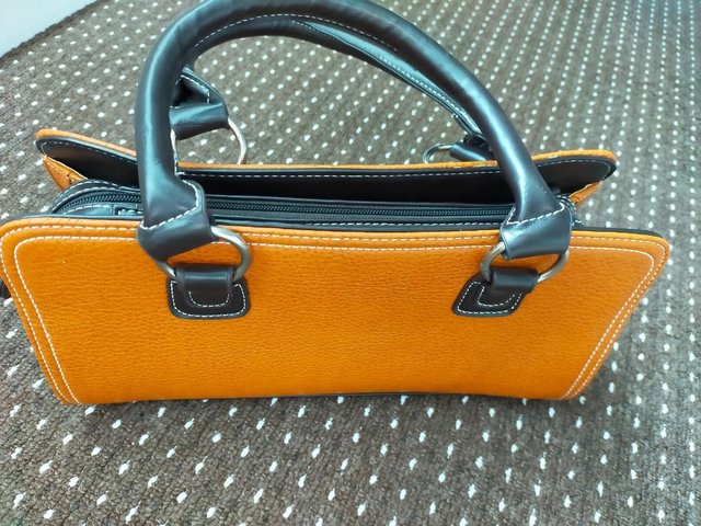 Preview of the first image of Ladies Black & Burnt Orange colour Handbag.
