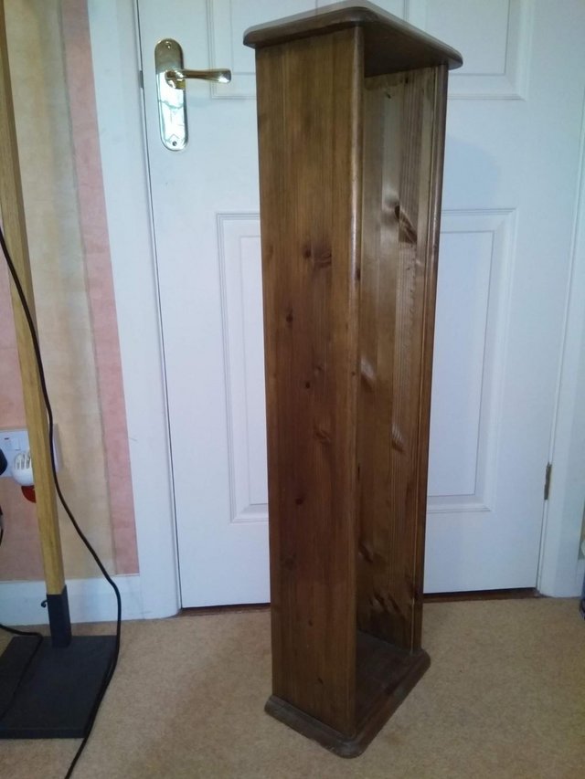 Preview of the first image of Tall, dark stained, pine storage unit.